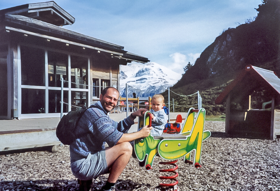 Bryan and his son Cooper at a playground in the Swiss Alps